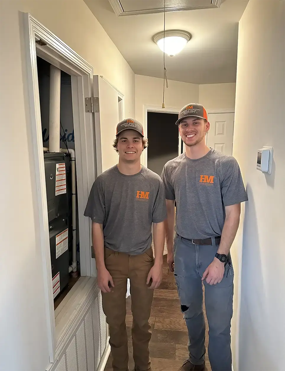 Two crew members of the Harmon Mechanical team